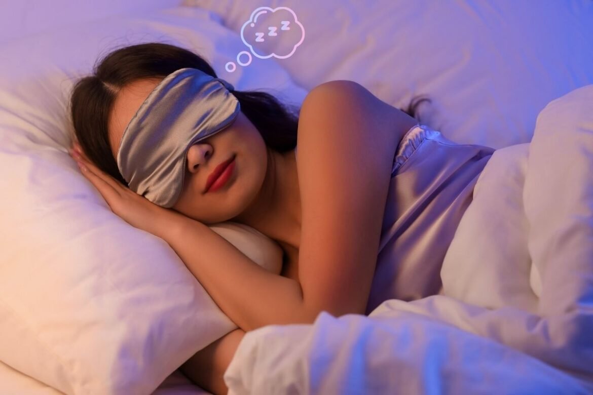 Woman with satin eye mask sleeping peacefully.